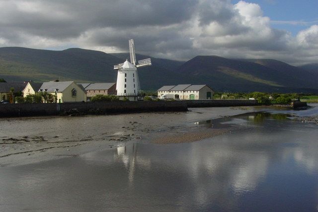 Blennerville Windmill by the water, with mountains behind